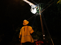 Utility crews make repairs in a Gaithersburg, Maryland neighborhood on June 5, 2024, after a tornado swept through the region. (