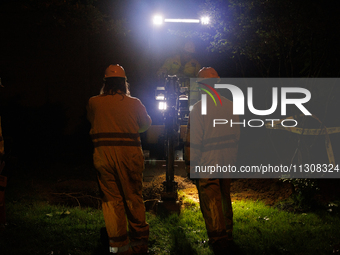 Workers from Washington Gas dig a hole on a property that was destroyed by a fallen tree in Gaithersburg, Maryland on June 5, 2024, after a...