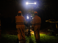 Workers from Washington Gas dig a hole on a property that was destroyed by a fallen tree in Gaithersburg, Maryland on June 5, 2024, after a...