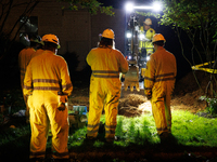 Workers from Washington Gas dig a hole on a property that was destroyed by a fallen tree in Gaithersburg, Maryland on June 5, 2024, after a...