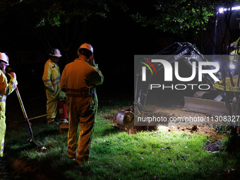 Workers from Washington Gas dig a hole on a property that was destroyed by a fallen tree in Gaithersburg, Maryland on June 5, 2024, after a...