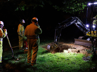 Workers from Washington Gas dig a hole on a property that was destroyed by a fallen tree in Gaithersburg, Maryland on June 5, 2024, after a...