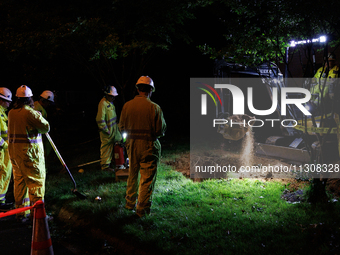 Workers from Washington Gas dig a hole on a property that was destroyed by a fallen tree in Gaithersburg, Maryland on June 5, 2024, after a...