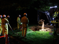 Workers from Washington Gas dig a hole on a property that was destroyed by a fallen tree in Gaithersburg, Maryland on June 5, 2024, after a...