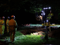 Workers from Washington Gas dig a hole on a property that was destroyed by a fallen tree in Gaithersburg, Maryland on June 5, 2024, after a...