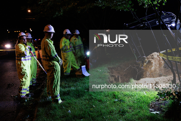 Workers from Washington Gas dig a hole on a property that was destroyed by a fallen tree in Gaithersburg, Maryland on June 5, 2024, after a...