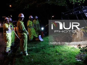 Workers from Washington Gas dig a hole on a property that was destroyed by a fallen tree in Gaithersburg, Maryland on June 5, 2024, after a...