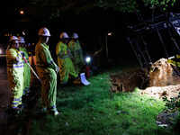 Workers from Washington Gas dig a hole on a property that was destroyed by a fallen tree in Gaithersburg, Maryland on June 5, 2024, after a...