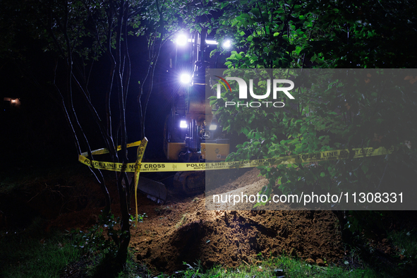 Workers from Washington Gas dig a hole on a property that was destroyed by a fallen tree in Gaithersburg, Maryland on June 5, 2024, after a...