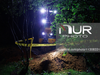 Workers from Washington Gas dig a hole on a property that was destroyed by a fallen tree in Gaithersburg, Maryland on June 5, 2024, after a...