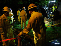 Workers from Washington Gas dig a hole on a property that was destroyed by a fallen tree in Gaithersburg, Maryland on June 5, 2024, after a...