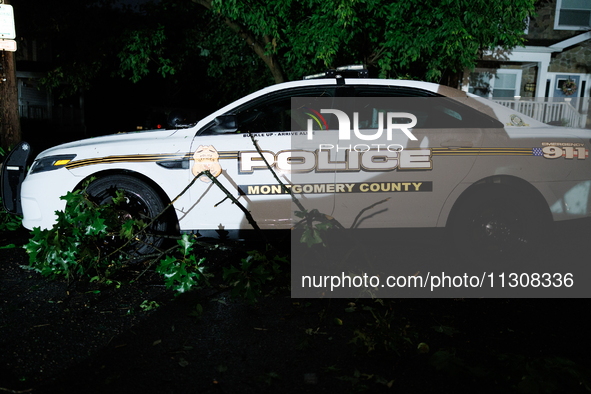 Debris lies around a Montgomery County Police vehicle after a tornado swept through a Gaithersburg, Maryland neighborhood on June 5, 2024. 