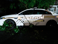 Debris lies around a Montgomery County Police vehicle after a tornado swept through a Gaithersburg, Maryland neighborhood on June 5, 2024. (