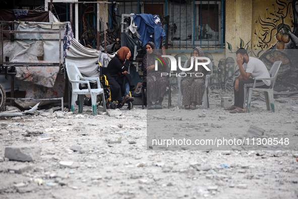 Palestinians are gathering at a UN-school that was hit during Israeli bombardment in Nuseirat, in the central Gaza Strip, on June 6, 2024, a...