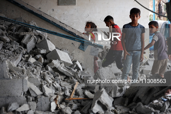 Palestinians are checking a UN-school that was hit during Israeli bombardment in Nuseirat, in the central Gaza Strip, on June 6, 2024, amid...