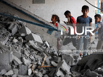 Palestinians are checking a UN-school that was hit during Israeli bombardment in Nuseirat, in the central Gaza Strip, on June 6, 2024, amid...