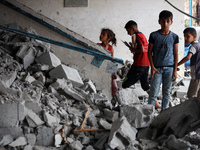 Palestinians are checking a UN-school that was hit during Israeli bombardment in Nuseirat, in the central Gaza Strip, on June 6, 2024, amid...