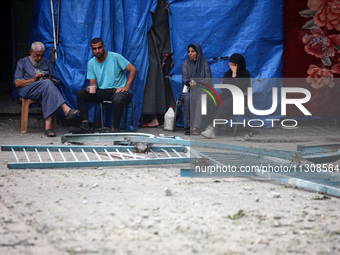 Palestinians are gathering at a UN-school that was hit during Israeli bombardment in Nuseirat, in the central Gaza Strip, on June 6, 2024, a...