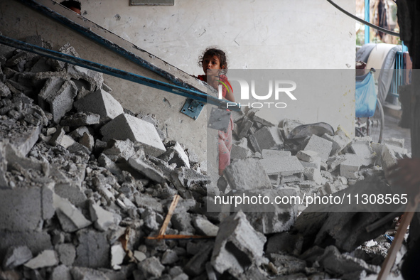 Palestinians are checking a UN-school that was hit during Israeli bombardment in Nuseirat, in the central Gaza Strip, on June 6, 2024, amid...