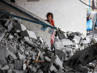 Palestinians are checking a UN-school that was hit during Israeli bombardment in Nuseirat, in the central Gaza Strip, on June 6, 2024, amid...