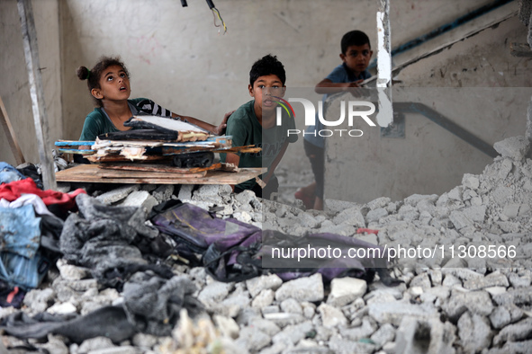 Palestinians are checking a UN-school that was hit during Israeli bombardment in Nuseirat, in the central Gaza Strip, on June 6, 2024, amid...