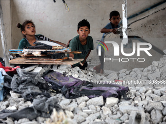 Palestinians are checking a UN-school that was hit during Israeli bombardment in Nuseirat, in the central Gaza Strip, on June 6, 2024, amid...