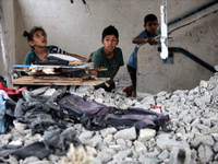 Palestinians are checking a UN-school that was hit during Israeli bombardment in Nuseirat, in the central Gaza Strip, on June 6, 2024, amid...