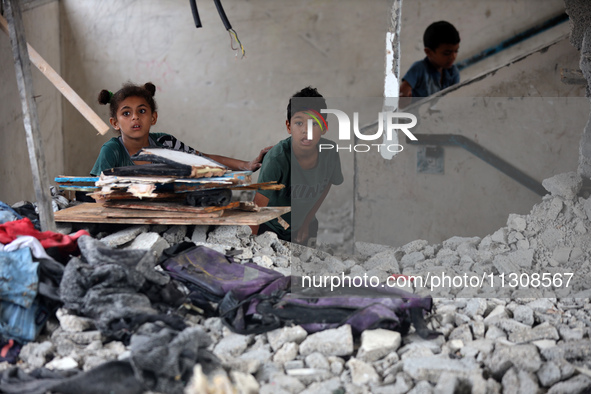 Palestinians are checking a UN-school that was hit during Israeli bombardment in Nuseirat, in the central Gaza Strip, on June 6, 2024, amid...