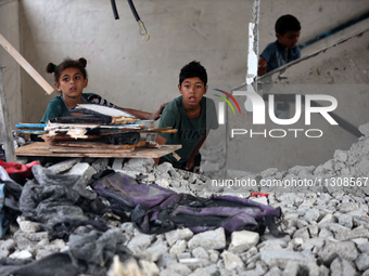 Palestinians are checking a UN-school that was hit during Israeli bombardment in Nuseirat, in the central Gaza Strip, on June 6, 2024, amid...