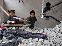 Palestinians are checking a UN-school that was hit during Israeli bombardment in Nuseirat, in the central Gaza Strip, on June 6, 2024, amid...