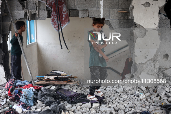 Palestinians are checking a UN-school that was hit during Israeli bombardment in Nuseirat, in the central Gaza Strip, on June 6, 2024, amid...