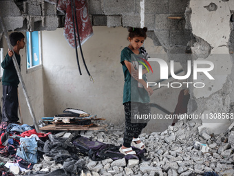 Palestinians are checking a UN-school that was hit during Israeli bombardment in Nuseirat, in the central Gaza Strip, on June 6, 2024, amid...