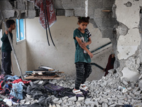 Palestinians are checking a UN-school that was hit during Israeli bombardment in Nuseirat, in the central Gaza Strip, on June 6, 2024, amid...