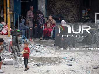 Palestinians are gathering at a UN-school that was hit during Israeli bombardment in Nuseirat, in the central Gaza Strip, on June 6, 2024, a...