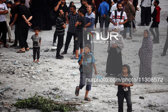 Palestinians are gathering at a UN-school that was hit during Israeli bombardment in Nuseirat, in the central Gaza Strip, on June 6, 2024, a...