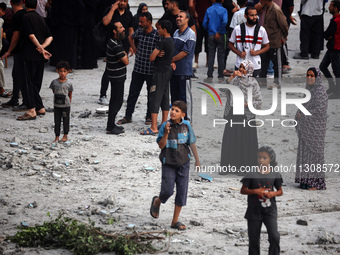 Palestinians are gathering at a UN-school that was hit during Israeli bombardment in Nuseirat, in the central Gaza Strip, on June 6, 2024, a...