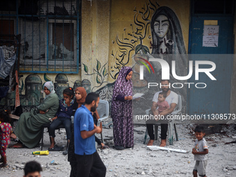 Palestinians are gathering at a UN-school that was hit during Israeli bombardment in Nuseirat, in the central Gaza Strip, on June 6, 2024, a...