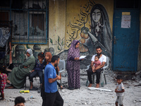 Palestinians are gathering at a UN-school that was hit during Israeli bombardment in Nuseirat, in the central Gaza Strip, on June 6, 2024, a...