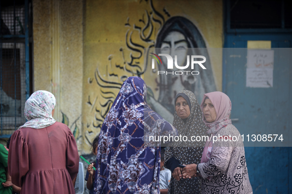 Palestinians are gathering at a UN-school that was hit during Israeli bombardment in Nuseirat, in the central Gaza Strip, on June 6, 2024, a...