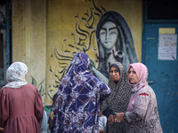 Palestinians are gathering at a UN-school that was hit during Israeli bombardment in Nuseirat, in the central Gaza Strip, on June 6, 2024, a...