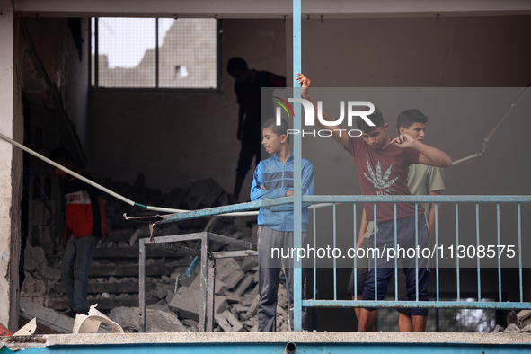 Palestinians are checking a UN-school that was hit during Israeli bombardment in Nuseirat, in the central Gaza Strip, on June 6, 2024, amid...