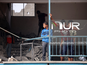 Palestinians are checking a UN-school that was hit during Israeli bombardment in Nuseirat, in the central Gaza Strip, on June 6, 2024, amid...