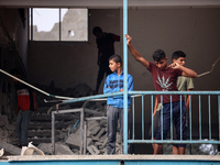 Palestinians are checking a UN-school that was hit during Israeli bombardment in Nuseirat, in the central Gaza Strip, on June 6, 2024, amid...