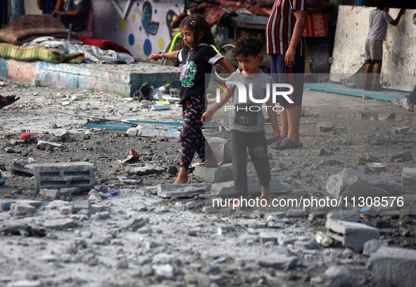 Palestinians are gathering at a UN-school that was hit during Israeli bombardment in Nuseirat, in the central Gaza Strip, on June 6, 2024, a...