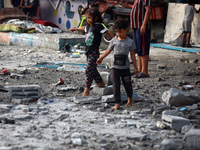 Palestinians are gathering at a UN-school that was hit during Israeli bombardment in Nuseirat, in the central Gaza Strip, on June 6, 2024, a...