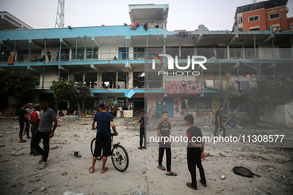 Palestinians are gathering at a UN-school that was hit during Israeli bombardment in Nuseirat, in the central Gaza Strip, on June 6, 2024, a...