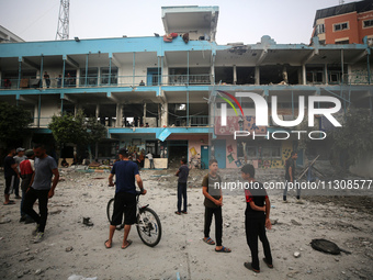 Palestinians are gathering at a UN-school that was hit during Israeli bombardment in Nuseirat, in the central Gaza Strip, on June 6, 2024, a...