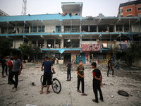 Palestinians are gathering at a UN-school that was hit during Israeli bombardment in Nuseirat, in the central Gaza Strip, on June 6, 2024, a...