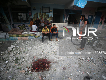 Palestinians are gathering at a UN-school that was hit during Israeli bombardment in Nuseirat, in the central Gaza Strip, on June 6, 2024, a...