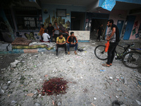 Palestinians are gathering at a UN-school that was hit during Israeli bombardment in Nuseirat, in the central Gaza Strip, on June 6, 2024, a...